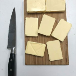black handled knife beside cheese
