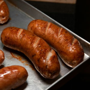 brown sausage on stainless steel tray